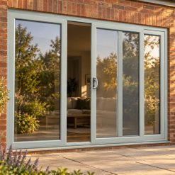 Agate Grey uPVC 3 pane sliding patio door opening onto a garden patio