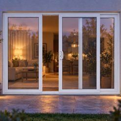 White uPVC 3 pane sliding patio door lit up in the evening