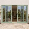 Chartwell Green uPVC 4 pane sliding patio door fitted to the back of a house