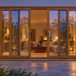 Golden Oak uPVC 4 pane sliding patio door lit up in the evening