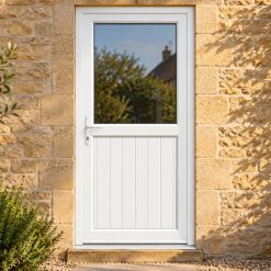 Half Glazed uPVC Single Door – Tongue & Groove Panel on a stone house