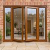 Golden Oak French Doors with Side Panels fitted to the back of a house