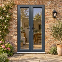 1190mm x 2090mm - Anthracite Grey on White uPVC French Doors lit up in the evening