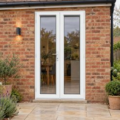 1190mm x 2090mm - White uPVC French Doors opening onto a brick patio