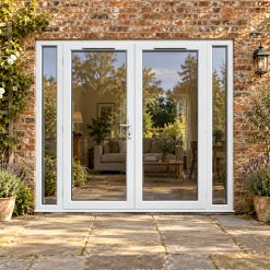 2390mm x 2090mm - White uPVC French Doors with Narrow Side Panels lit up in the evening