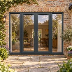 2690mm x 2090mm - Grey-on-White uPVC French Doors with Wide Side Panels lit up in the evening
