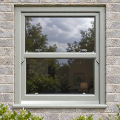 Agate Grey uPVC sliding sash window on a modern brick house