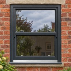 Anthracite Grey uPVC sliding sash window on a red brick house