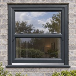 Anthracite Grey uPVC sliding sash window on a modern brick house