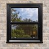 Black/Brown uPVC sliding sash window fitted in a brick house