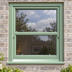 Chartwell Green uPVC sliding sash window on a modern brick house