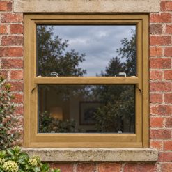 Irish Oak uPVC sliding sash window on a red brick house