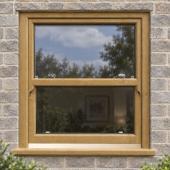 Irish Oak uPVC sliding sash window on a modern brick house