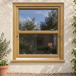 Irish Oak uPVC sliding sash window on a rendered cottage