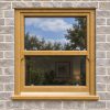 Irish Oak uPVC sliding sash window fitted in a brick house