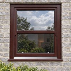 Rosewood uPVC sliding sash window on a modern brick house