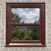 Rosewood uPVC sliding sash window fitted in a brick house