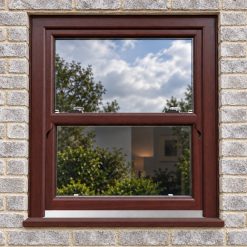 Rosewood uPVC sliding sash window fitted in a brick house