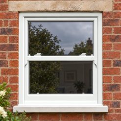 White uPVC sliding sash window on a red brick house