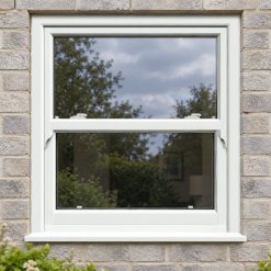White uPVC sliding sash window on a modern brick house