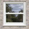 White uPVC sliding sash window fitted in a brick house